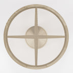 Croisillon de bois vu à travers le plateau de verre bronze de la table Vasco en chêne naturel