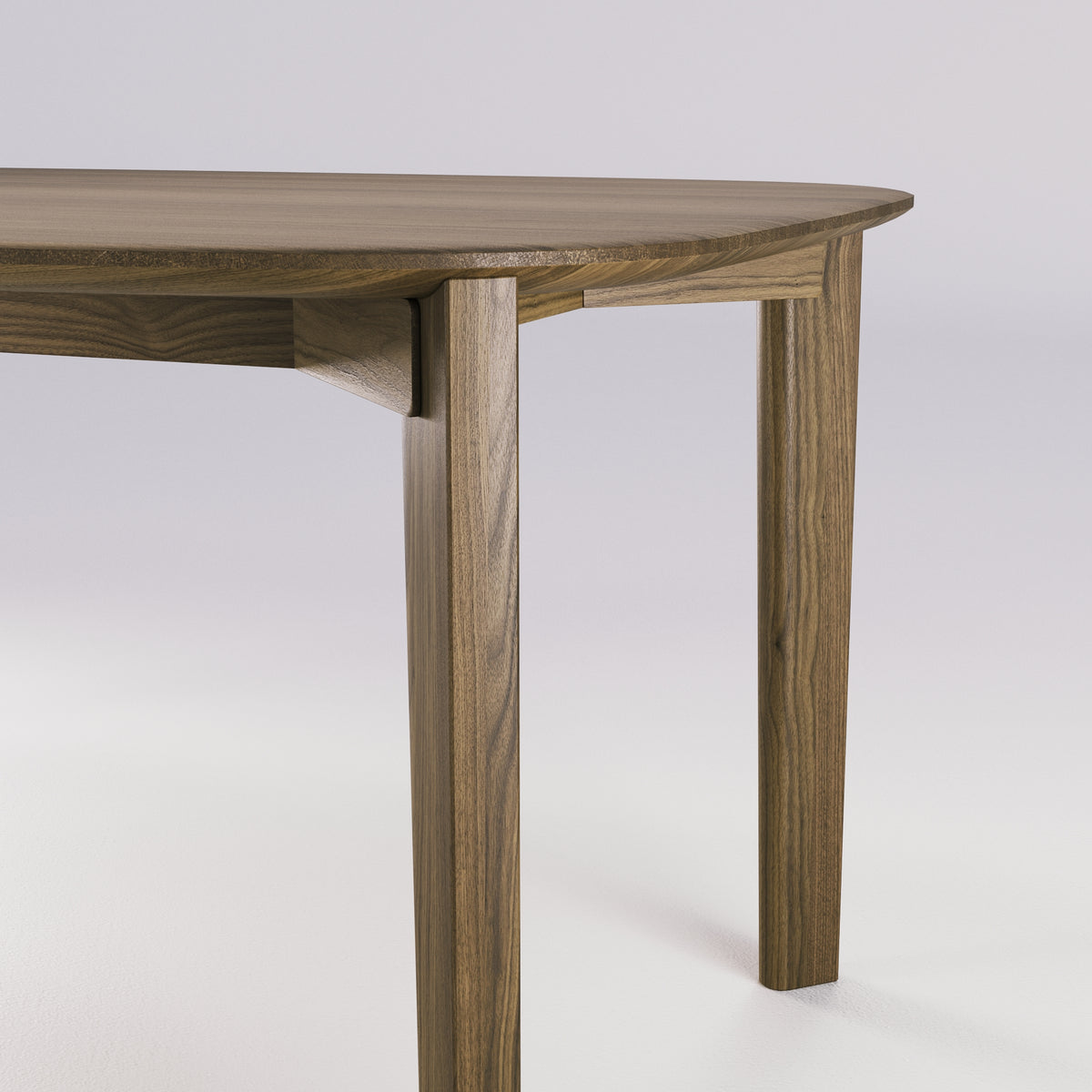 Jonction de la ceinture et d'un pied de la table Soma en noyer foncé