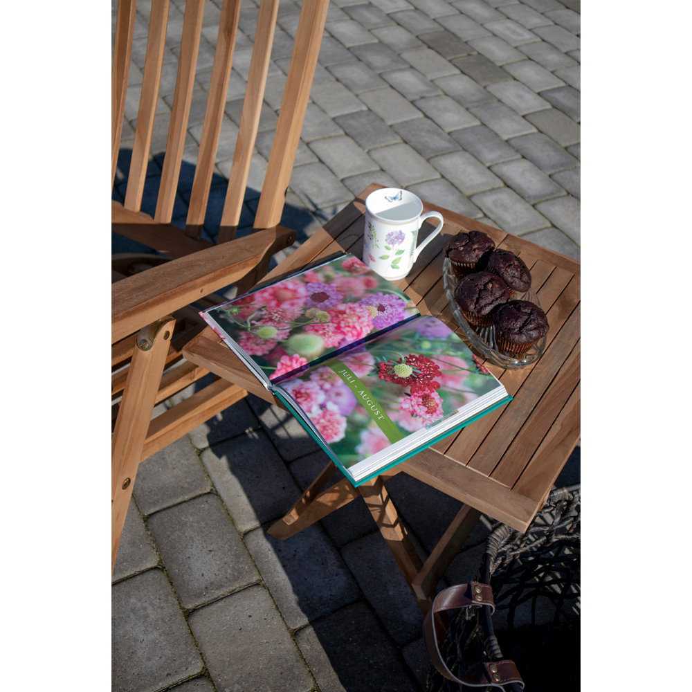 Vue dessus table Bilbao teck avec magazine ouvert et tasse café en extérieur