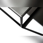 Angle du plateau en béton posé sur le cadre en acier noir de la table Perspective