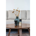 Table basse Hellerup noyer vue salon avec canapé d'angle gris clair et décoration