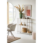 Tableau Mina N°1 terracotta accroché au-dessus d'une console en métal beige près d'un grand miroir rond