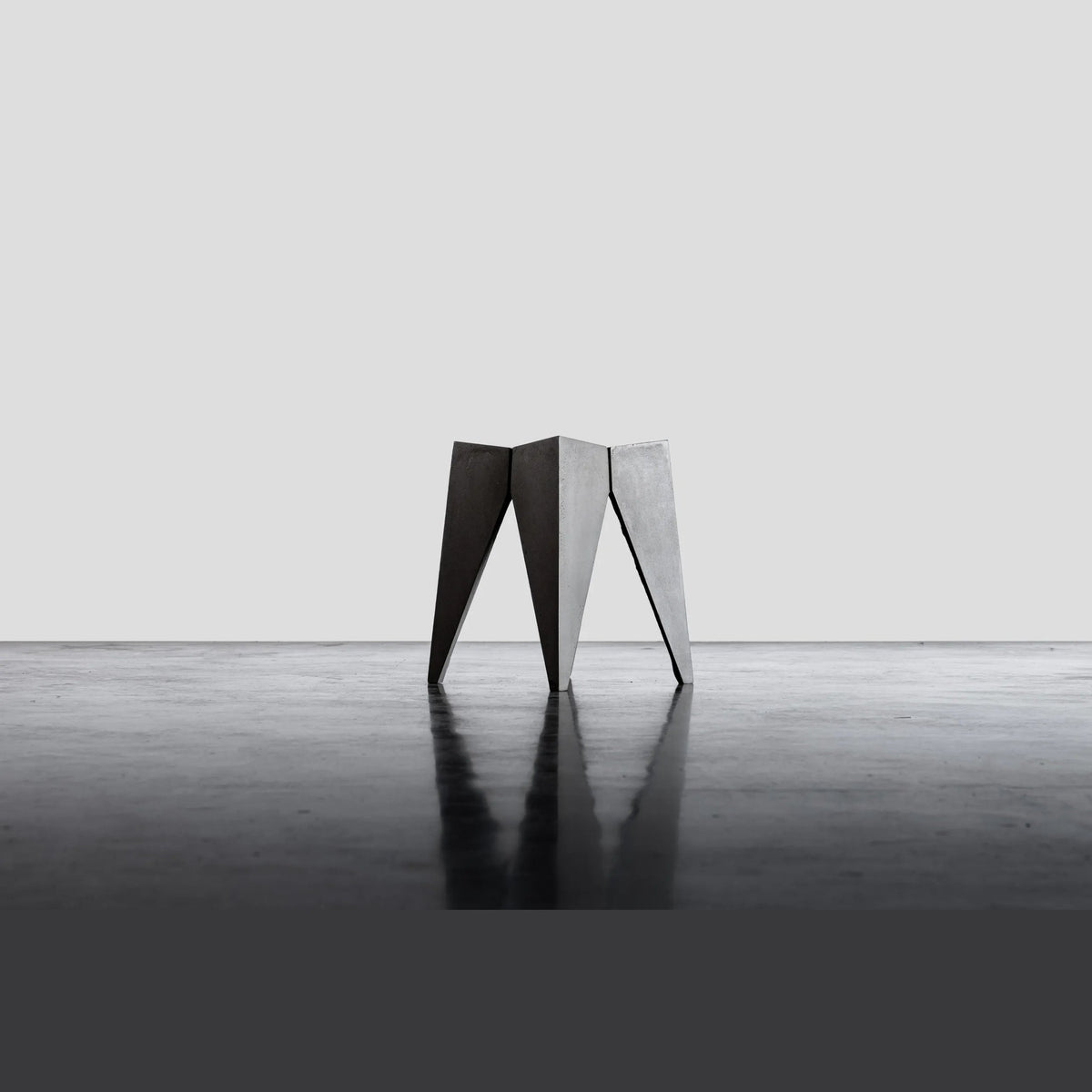 Tabouret Bridge en béton vu de profil avec la silhouette évasée de ses pieds